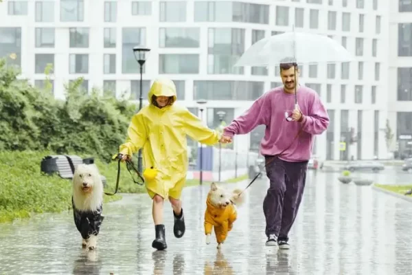 this image shows a family running in the rain with rain jackets on